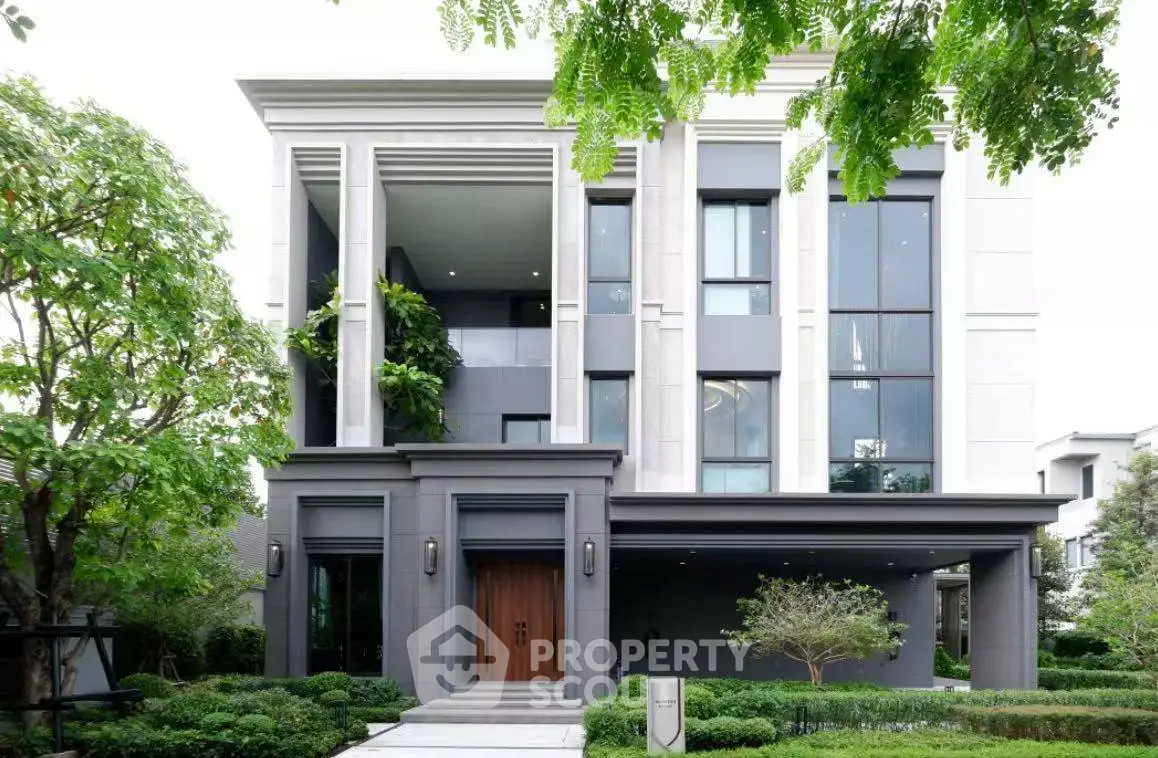 Luxurious modern house exterior with lush greenery and elegant architectural design.
