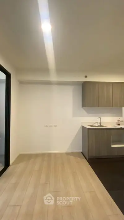 Modern kitchen with sleek cabinetry and open layout in a contemporary apartment.