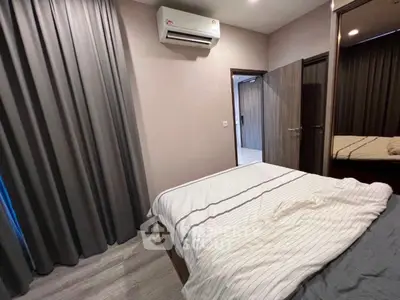 Cozy bedroom with modern air conditioning and elegant drapes, perfect for restful nights.