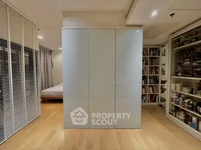 Modern bedroom with sleek wardrobe and cozy reading nook