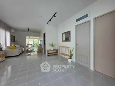 Spacious modern living room with sleek tile flooring and stylish decor