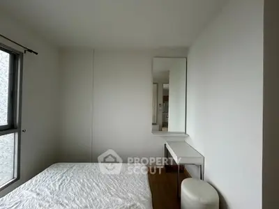 Minimalist bedroom with large window and sleek furniture design
