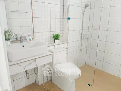 Modern bathroom with sleek fixtures and glass shower enclosure