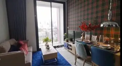 Chic living room with modern decor and balcony access in stylish apartment.