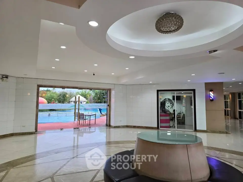 Luxurious building lobby with pool view and modern design