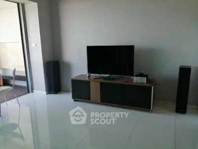 Modern living room with sleek TV setup and balcony view