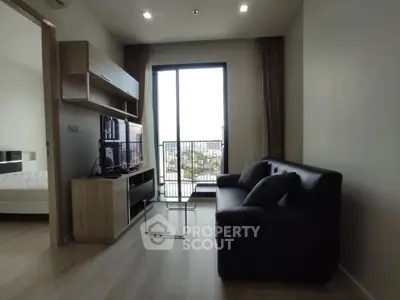Modern living room with sleek furniture and city view from balcony
