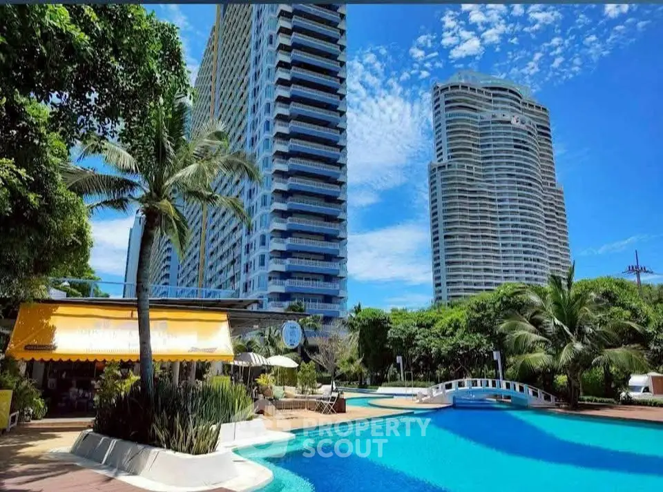 Luxurious high-rise buildings with a stunning pool and lush greenery, perfect for upscale living.
