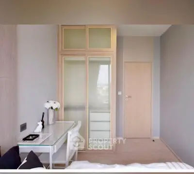 Modern bedroom with sleek furniture and built-in wardrobe