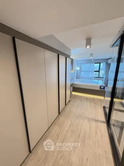 Modern bedroom with sleek design and large windows offering natural light