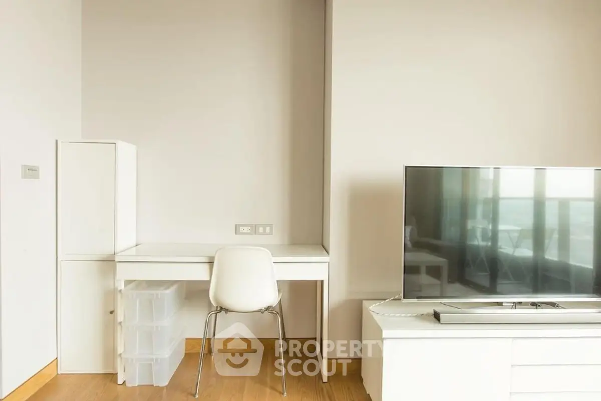Modern study area with sleek desk and TV in bright apartment