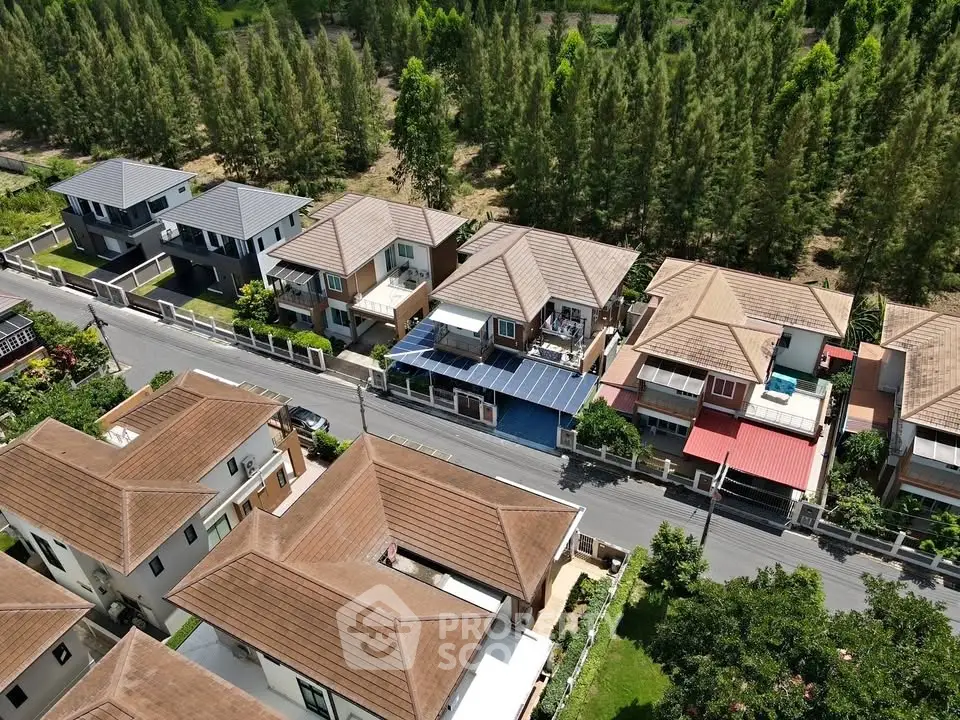 Aerial view of modern suburban houses with lush greenery and spacious layouts.