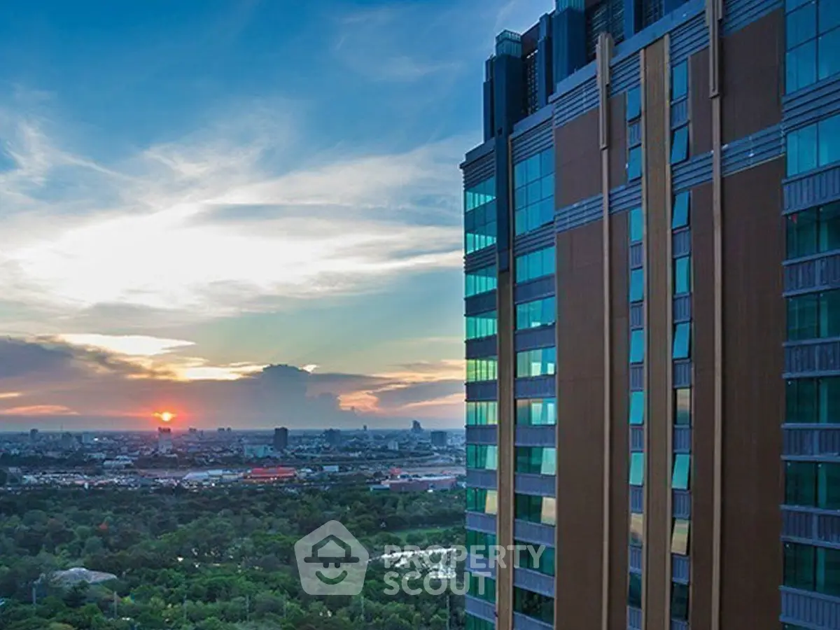 Stunning cityscape view from a modern high-rise building at sunset, showcasing urban living.