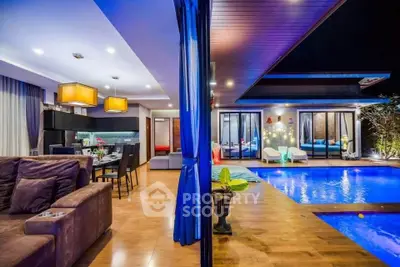 Luxurious open-plan living room with pool view, modern lighting, and elegant decor for ultimate relaxation.