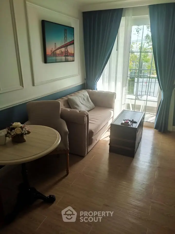 Charming living room with elegant decor and natural light, featuring a cozy sofa and stylish coffee table.