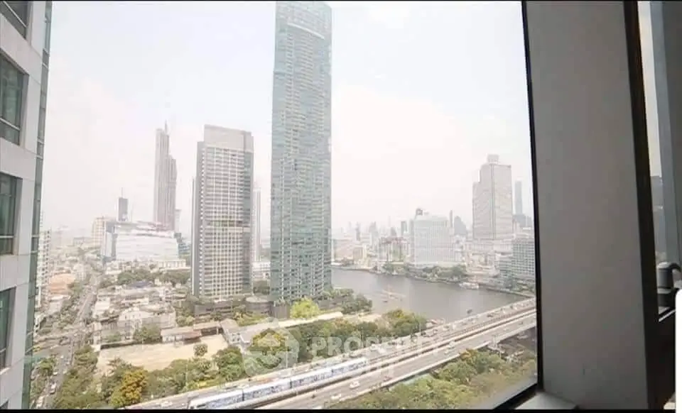 Stunning cityscape view from high-rise apartment window overlooking river and skyline.