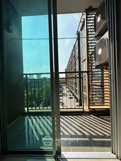 Modern apartment balcony with city view and air conditioning units
