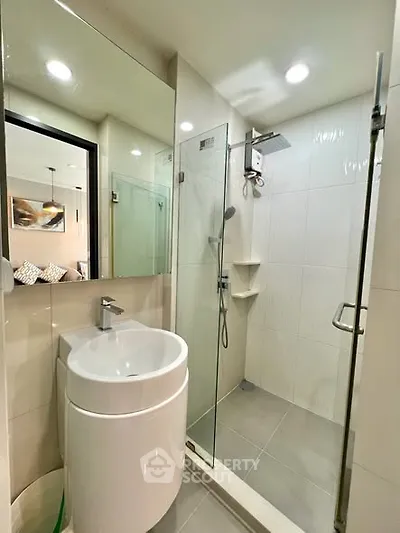 Modern bathroom with glass shower and sleek sink design