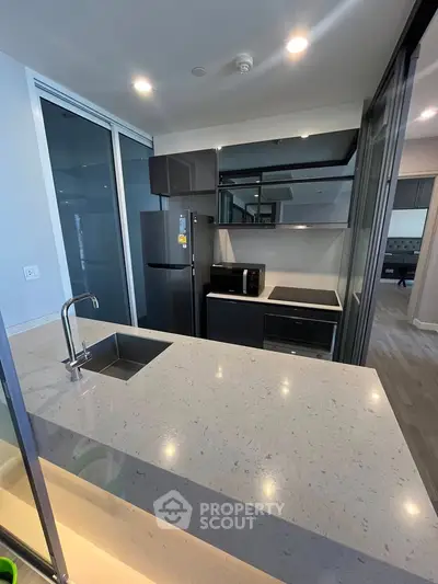Modern kitchen with sleek design, featuring stainless steel appliances and a spacious countertop.