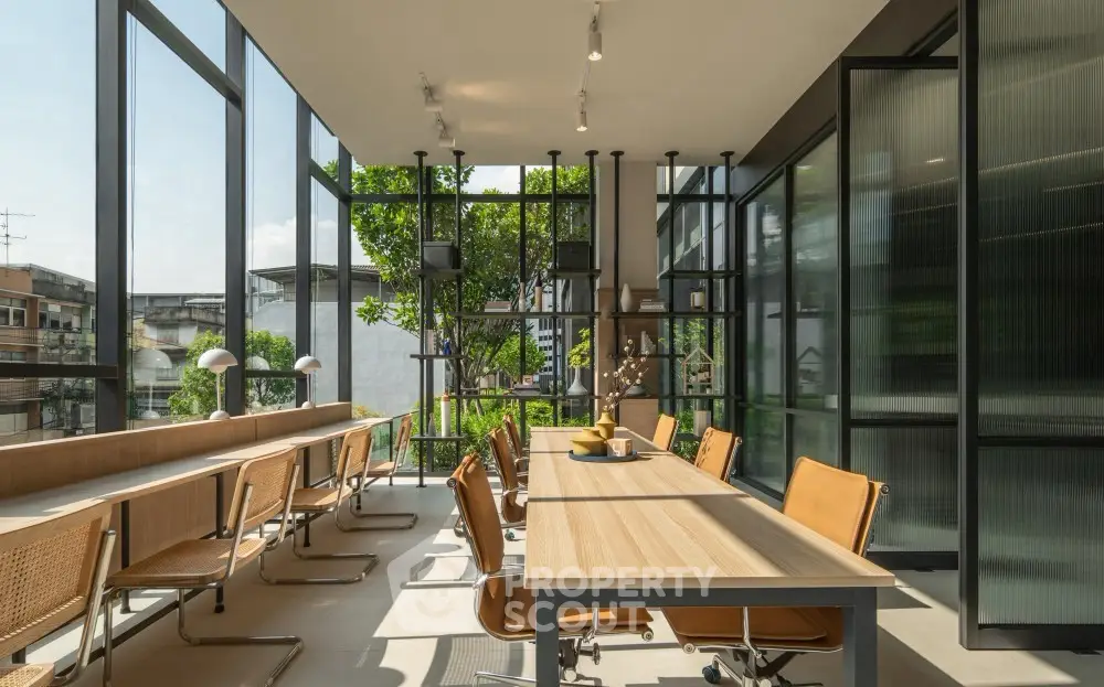 Modern co-working space with large windows and stylish furniture