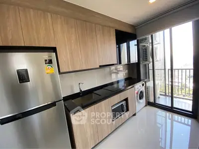 Modern kitchen with sleek appliances and balcony view