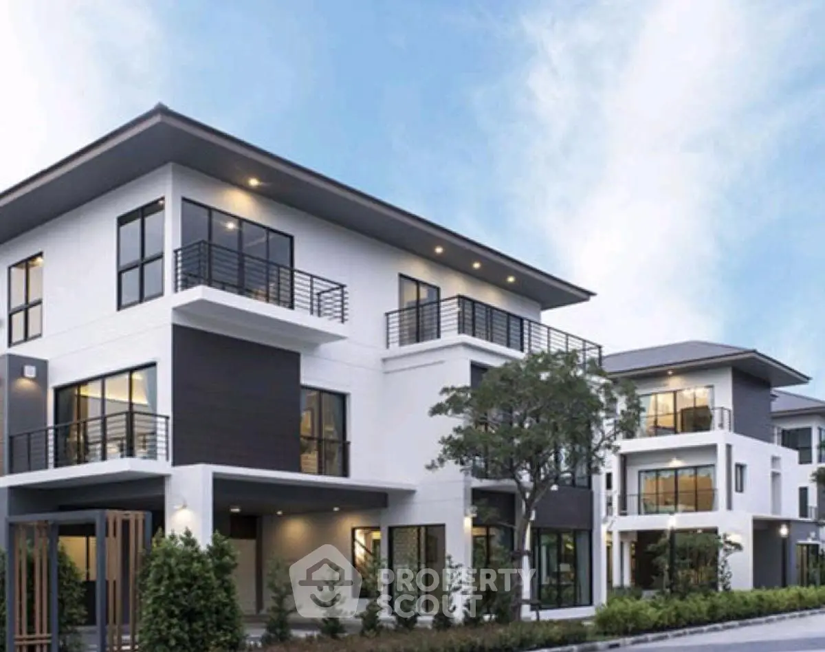 Modern multi-story residential building with sleek design and lush landscaping.