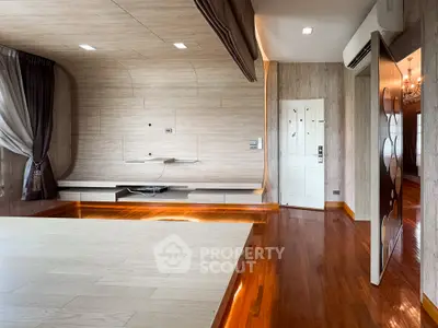 Spacious modern living room with wooden flooring and elegant wall design