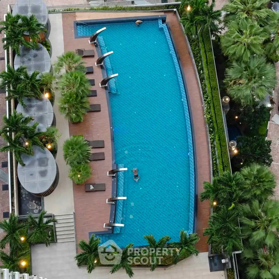Luxurious rooftop pool with lush greenery and modern design, perfect for relaxation and leisure.