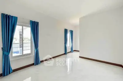 Spacious room with glossy floors and blue curtains, perfect for modern living.