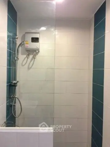 Modern bathroom with sleek shower and water heater, featuring stylish tile design.