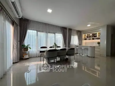 Spacious modern living room with elegant dining area and natural light