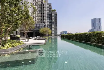 Luxurious rooftop pool with stunning city views and modern building architecture.