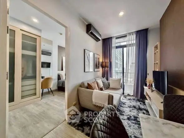 Modern living room with cozy decor and city view, featuring stylish furniture and open layout.