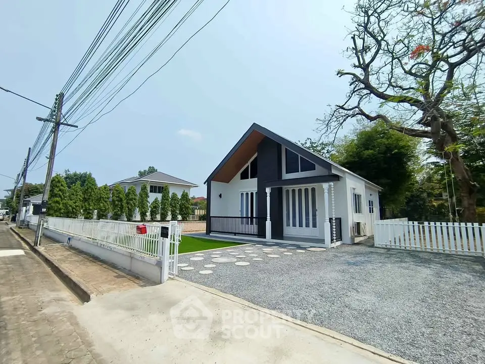 Charming modern house with spacious driveway and lush greenery, perfect for family living.