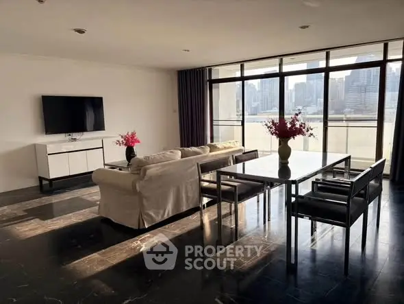 Spacious modern living room with city view, elegant furniture, and abundant natural light.