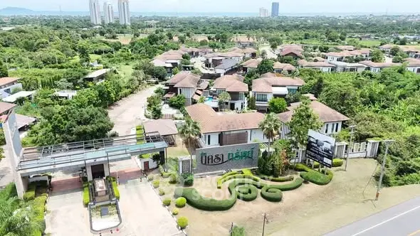 Aerial view of a modern residential community with lush greenery and stylish homes.