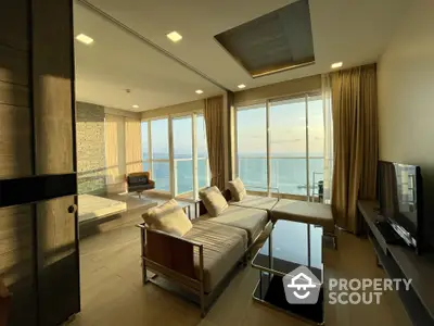 Luxurious beachfront living room with panoramic ocean views, modern furniture, and floor-to-ceiling windows inviting abundant natural light.