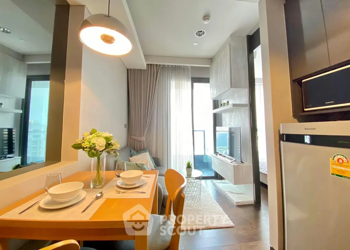 Modern living room with dining area and balcony access in a stylish apartment.