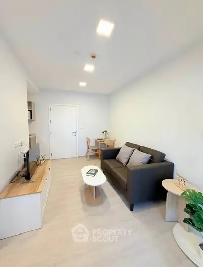 Modern living room with sleek furniture and bright lighting, perfect for relaxation and entertainment.