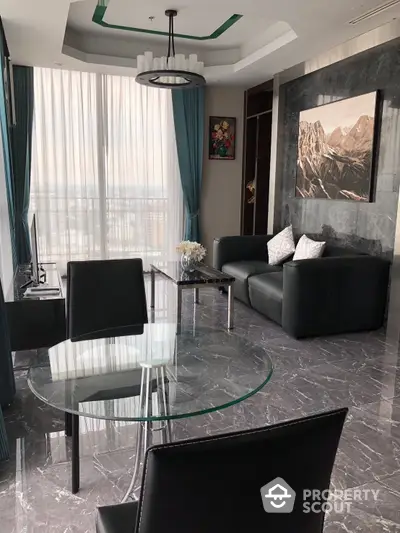 Elegant living room with polished marble flooring, modern furniture, and abundant natural light filtering through sheer curtains.