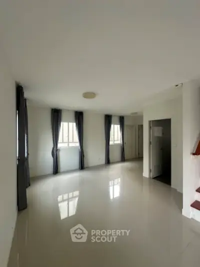 Spacious unfurnished living room with large windows and natural light