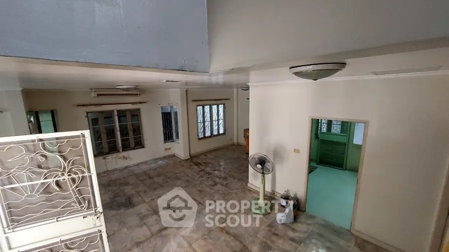 Spacious living room with tiled flooring and natural light, ideal for customization.
