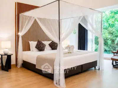 Luxurious bedroom with canopy bed and garden view, perfect for serene living.