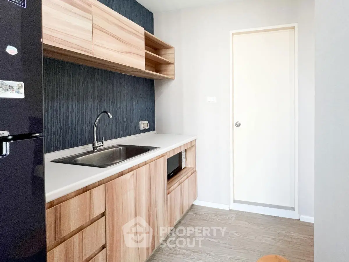 Modern kitchen with sleek wooden cabinets and stainless steel sink