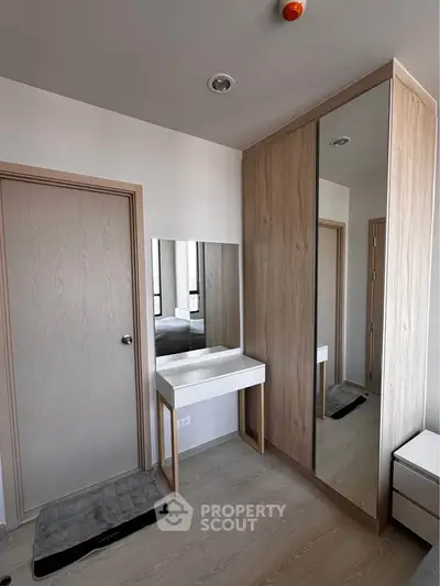 Modern bedroom with sleek wardrobe and vanity mirror