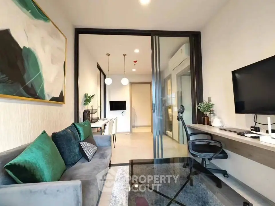 Modern living room with stylish decor and workspace, ideal for urban living.