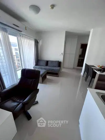 Modern living room with sleek furniture and natural light in a stylish apartment.