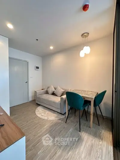 Modern living room with cozy sofa and dining area in a stylish apartment.