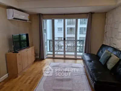 Modern living room with balcony view, air conditioning, and stylish decor.