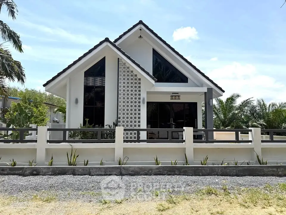 Charming modern house with unique architecture and lush surroundings, perfect for serene living.